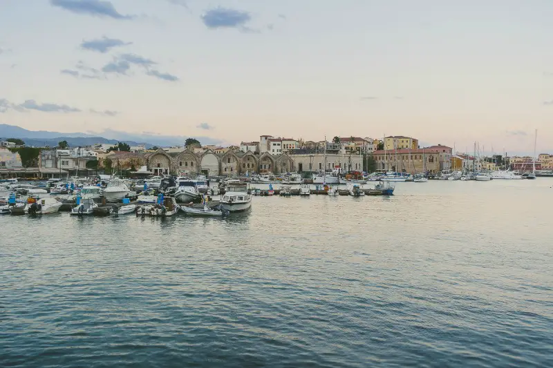 Food Styling and Photography Retreat – Crete, Greece 2017 www.thefoodiecorner.gr Photo description: A view from across the harbour of the old town of Chania, the fishing boats in the marina and the calm sea.