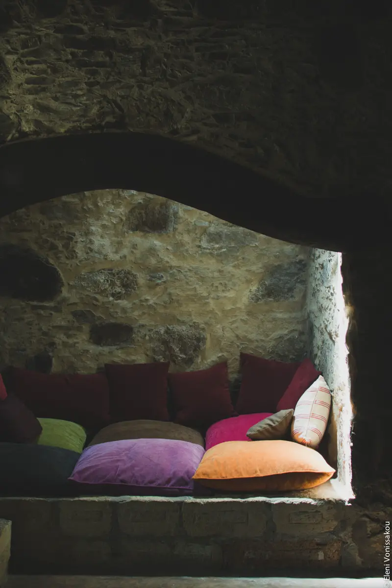 Milia Workshop 2017 – A long overdue recap. Part 1. www.thefoodiecorner.gr - Photo description: An inlet in a stone wall made into a sitting area with large colourful cushions. Light comes down from a skylight. 