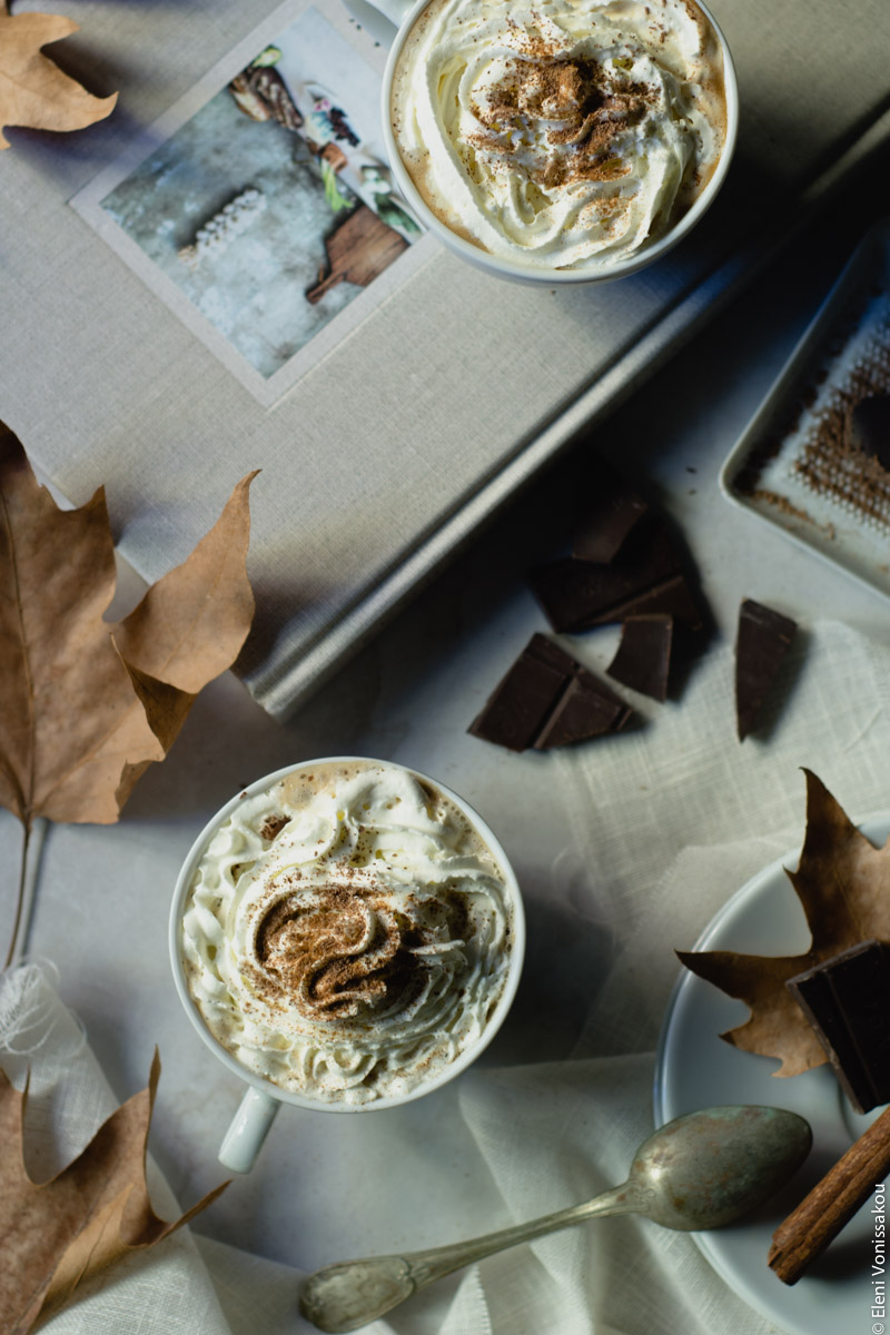 Homemade Pumpkin Spice Latte www.thefoodiecorner.gr 02 Photo description: Same setting as photo 01 but lattes are smothered in whipped cream with a sprinkling of spices and shaved chocolate on top.