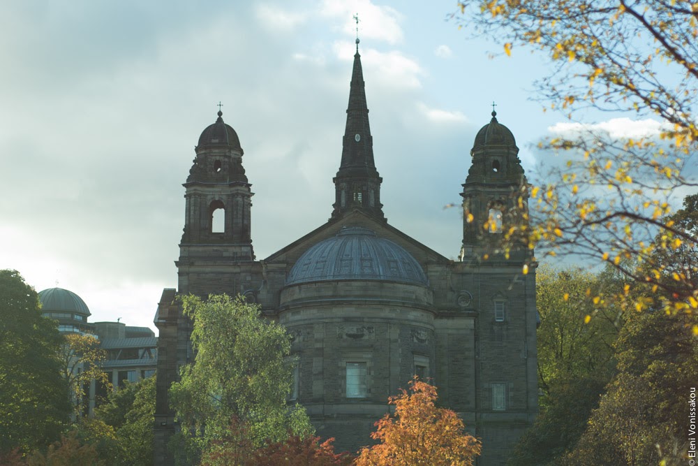 Butternut Squash Soup with Chilli and Whipped Goat’s Yoghurt Feta www.thefoodiecorner.gr Photo description: A church under a hazy blue grey sky, trees with autumn leaves in front of it (St. Cuthbert's in Princes Street Gardens)