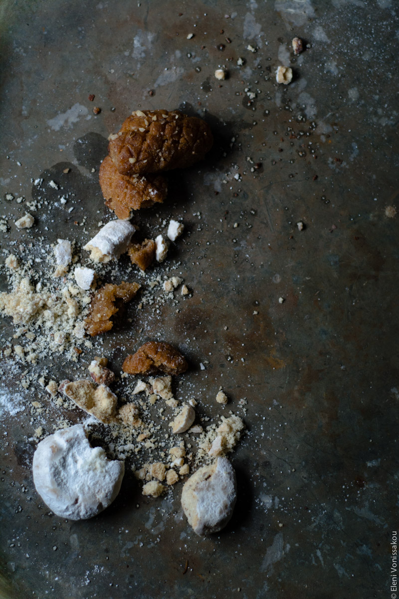 Brownies with Melomakarona and Kourabiedes - Aka Greek Christmas Brownies www.thefoodiecorner.gr Overhead view of the crumbled melomakarona and kourabiedes layed out in a downward messy line to the side of the metal grey surface.