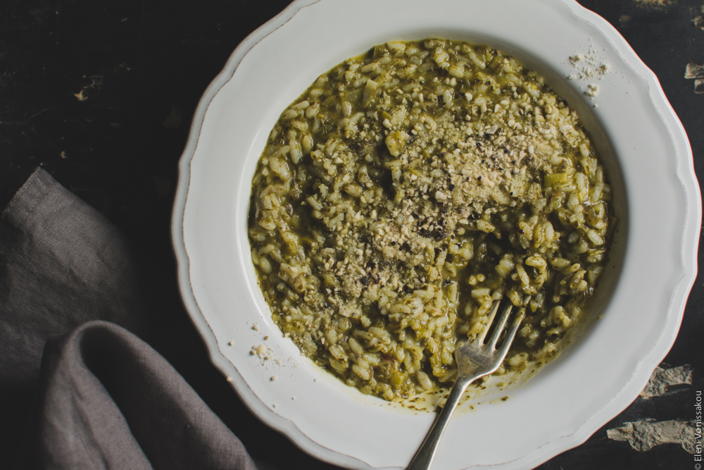 Vegan Risotto with Amaranth and Herbs www.thefoodiecorner.gr Photo description: A closer view of the plate of risotto, with a fork in it and some of the food missing. The juicy texture of the rice is more prominent in the shot.