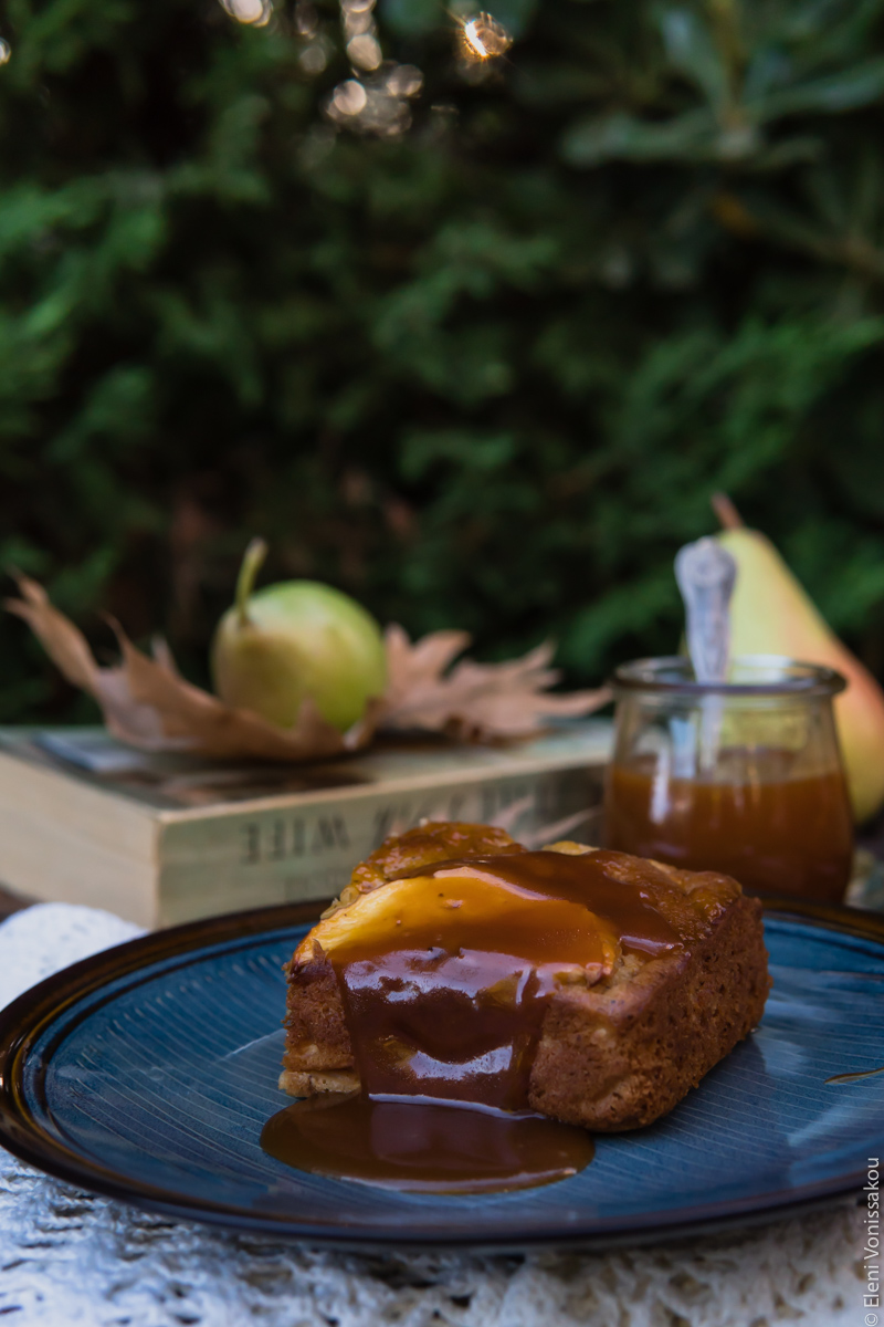 Easy, No Mixer Apple Cake with Salted Caramel Sauce www.thefoodiecorner.gr Photo description: Side view of a piece of cake on a plate. There is thick caramel dripping down the side facing us, pooling on the plate.