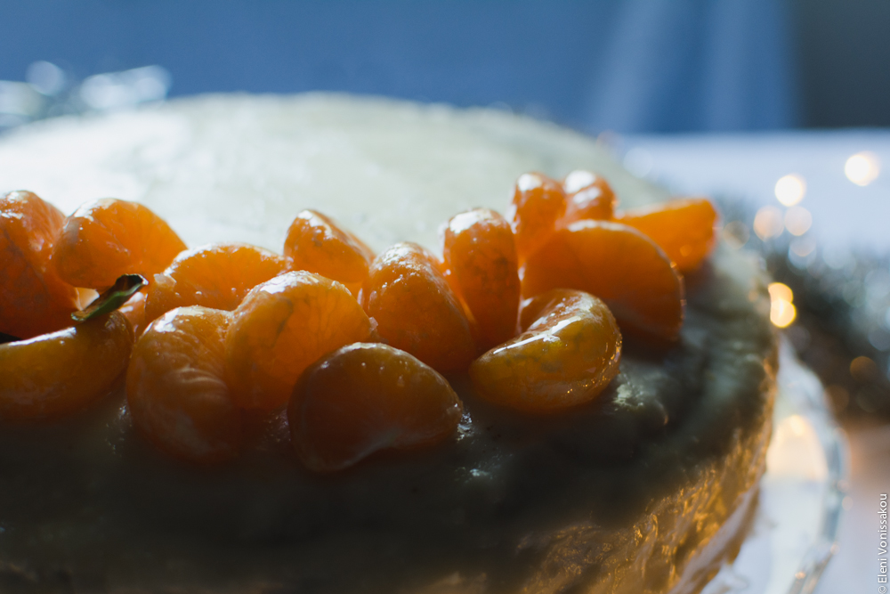 Greek New Year’s Cake (Vassilopita) with Mandarin, Almonds and Cardamom www.thefoodiecorner.gr Photo description: Another close view of the top of the cake, from the other side, with the light illuminating the mandarin segments.