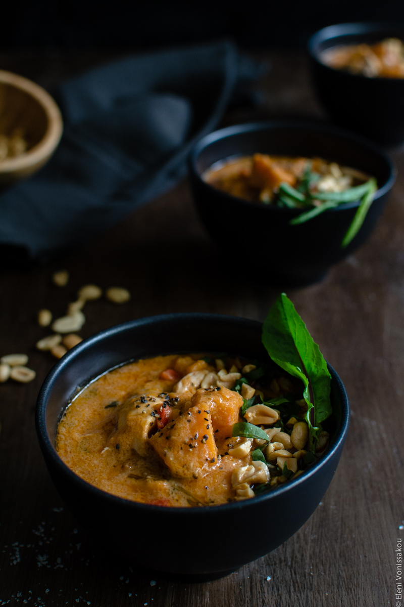 West African Inspired Chicken and Sweet Potato Soup with Peanut Butter www.thefoodiecorner.gr Photo description: A close up of one of the bowls of soup. In the dark background the two other bowls and a black tea towel barely visible.