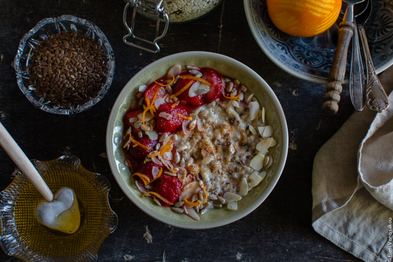 Oat Mix for Instant, Creamy Microwave Porridge (Oatmeal) www.thefoodiecorner.gr Photo description: A close up of a bowl of porridge. The surface is garnished with strawberries, almond flakes, sunflower seeds, orange zest, honey and cinnamon. 