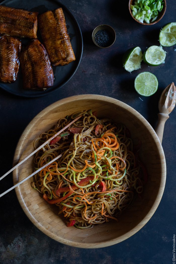 Easy Lo Mein with Salmon, Spaghetti, Veggie Noodles and Peanut Sauce www.thefoodiecorner.gr Photo description: A big bowl of veggie noodles mixed with whole wheat spaghetti and peanut sauce. To the top of the photo a plate of grilled salmon.