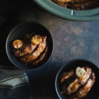 Slow Cooker Sweet-Bread Pudding with Banana, Peanut Butter and Chocolate Chips www.thefoodiecorner.gr Photo description: Two bowls with pudding inside sitting on a dark surface. In the top right corner of the photo, half visible, the slow cooker with pudding inside.