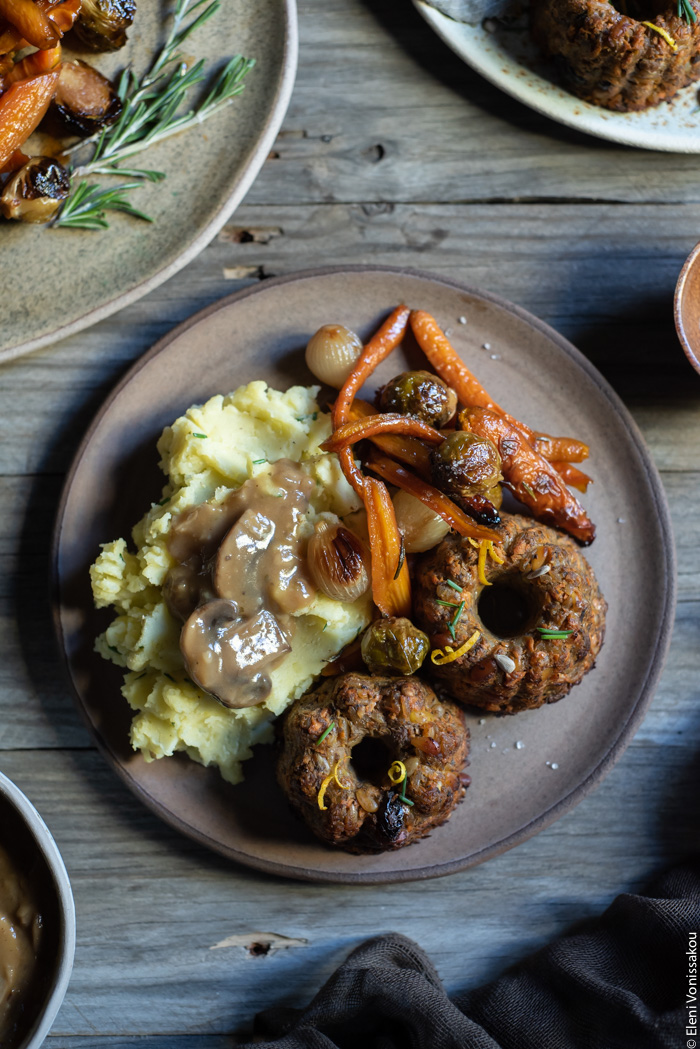 Sweet Wine Mushroom Gravy www.thefoodiecorner.gr Photo description: A plate filled with festive food. Mashed potatoes, roasted vegetables (Brussels sprouts and carrots) and muffin-shaped nut loaves smothered in mushroom gravy.