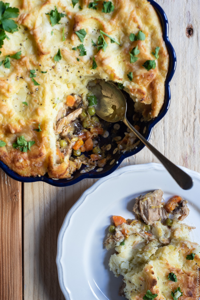 Shepherd’s Pie. To use up those Easter lamb leftovers. www.thefoodiecorner.gr Photo description: An overhead view of a shepherd’s pie in the top left corner of the image. Some of the pie has been removed, revealing the bottom layer of meat and vegetables in gravy. A serving spoon lies in the dish. In the bottom right corner of the image is a plate with a serving of pie on it. 