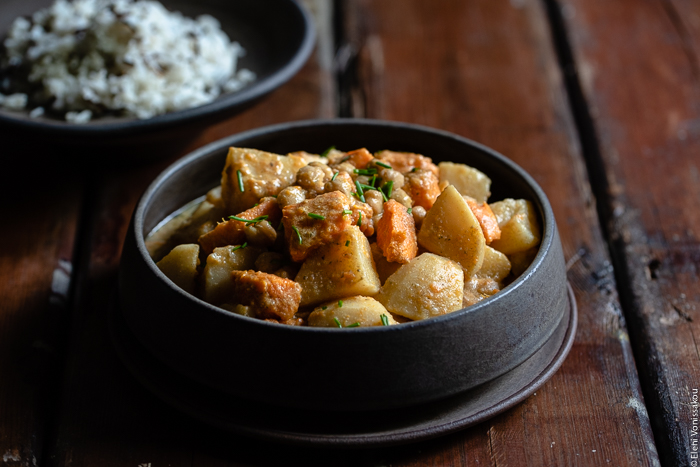 Slow Cooker Sweet Potato Chickpea Coconut Curry www.thefoodiecorner.gr Photo description: A close up, ¾ view of a large ceramic bowl with sweet potato chickpea coconut curry inside.