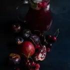 Ροζέ Σανγκρία με Ρόδι και Βυσσινάδα www.thefoodiecorner.gr Photo description: A jug of sangria with some oversized ice cubes, cherries and mint to garnish. In front of the jug are lots of red fruits (a cut pomegranate, cherries, plums and raspberries).
