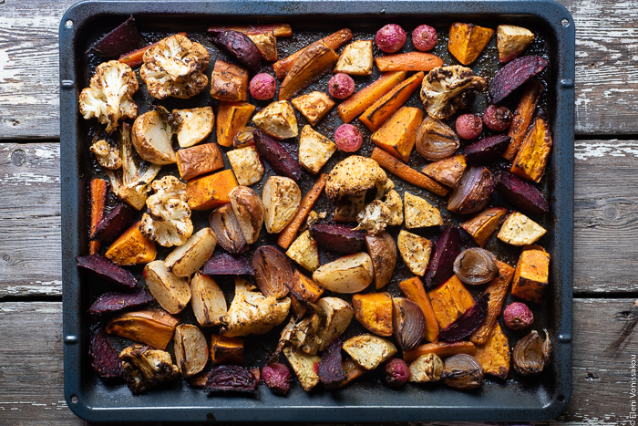 Cumin Roasted Root Vegetable Medley. My Winter “Briam”. www.thefoodiecorner.gr Photo description: Roasted root vegetables and cauliflower spread out on a baking dish ready to be served.