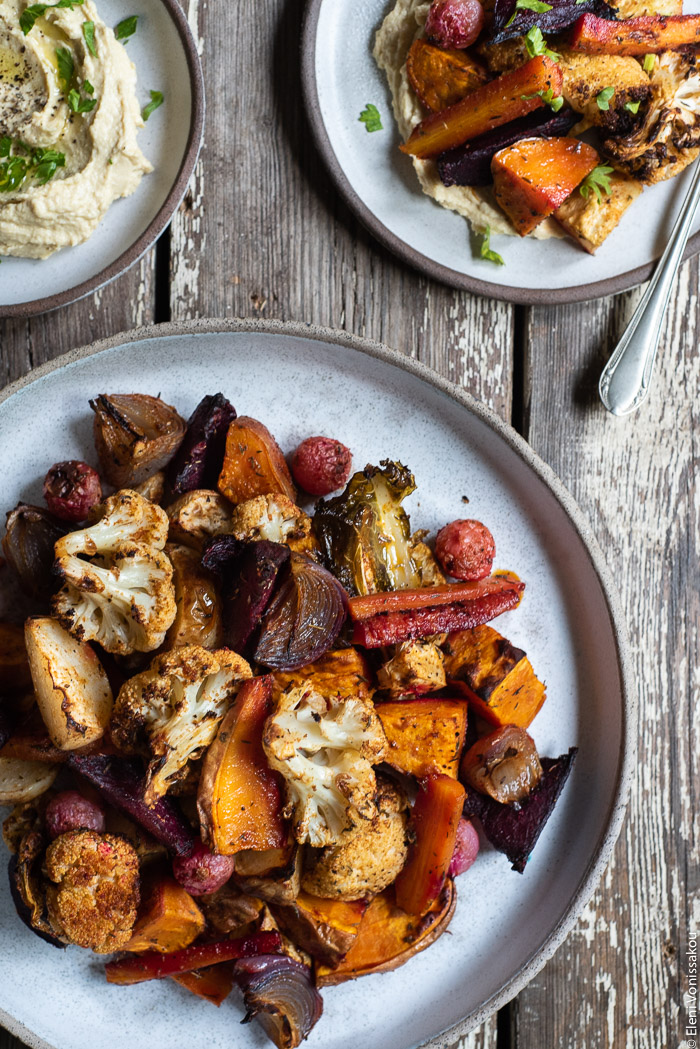 Cumin Roasted Root Vegetable Medley. My Winter “Briam”. www.thefoodiecorner.gr Photo description: A closer view of the roasted root vegetables (winter briam) on a ceramic dish. To the top right, half visible, is a small plate with hummus and roasted veg.