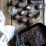 Chocolate Tahini Olive Oil Cookies or Brownies (One Recipe, Two Treats) www.thefoodiecorner.gr Photo description: A cooling rack with cookies on it and a baking dish with brownies, one of them missing. To the side of the dish lies a linen napkin. Everything is on a distressed wooden surface.