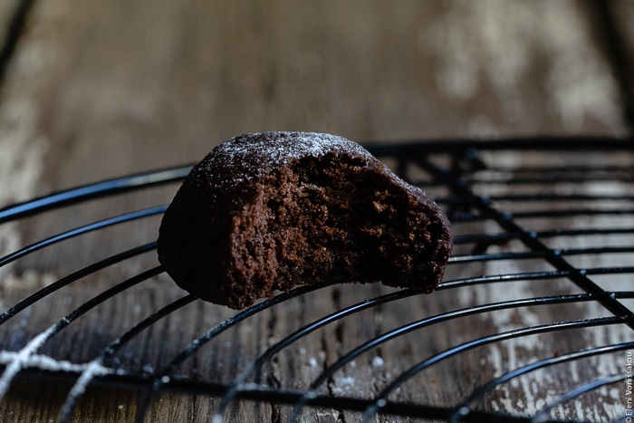 Chocolate Tahini Olive Oil Cookies or Brownies (One Recipe, Two Treats) www.thefoodiecorner.gr Photo description: A close view of a domed-shaped chocolate biscuit/cookie on a cooling rack. A bite is missing, revealing the inside.