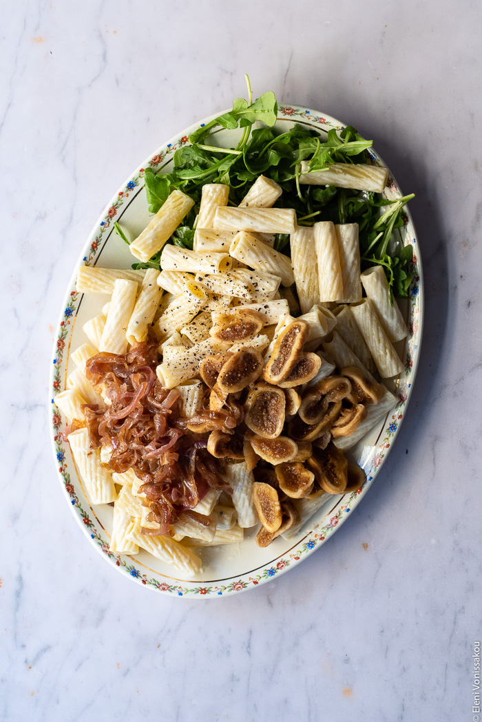 Caramelised Onion, Fig and Fresh Cheese Pasta with Arugula www.thefoodiecorner.gr Photo description: a platter with the elements of the dish before being tossed together. 