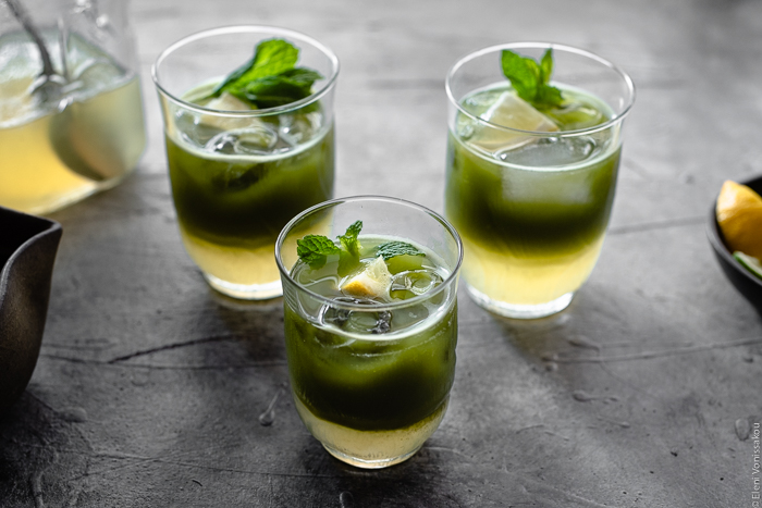 Easy Homemade Matcha Lemonade www.thefoodiecorner.gr Photo description: A close up, back lit view of three glasses of matcha lemonade, their two layers visible (lemonade at the bottom and matcha sitting on top).