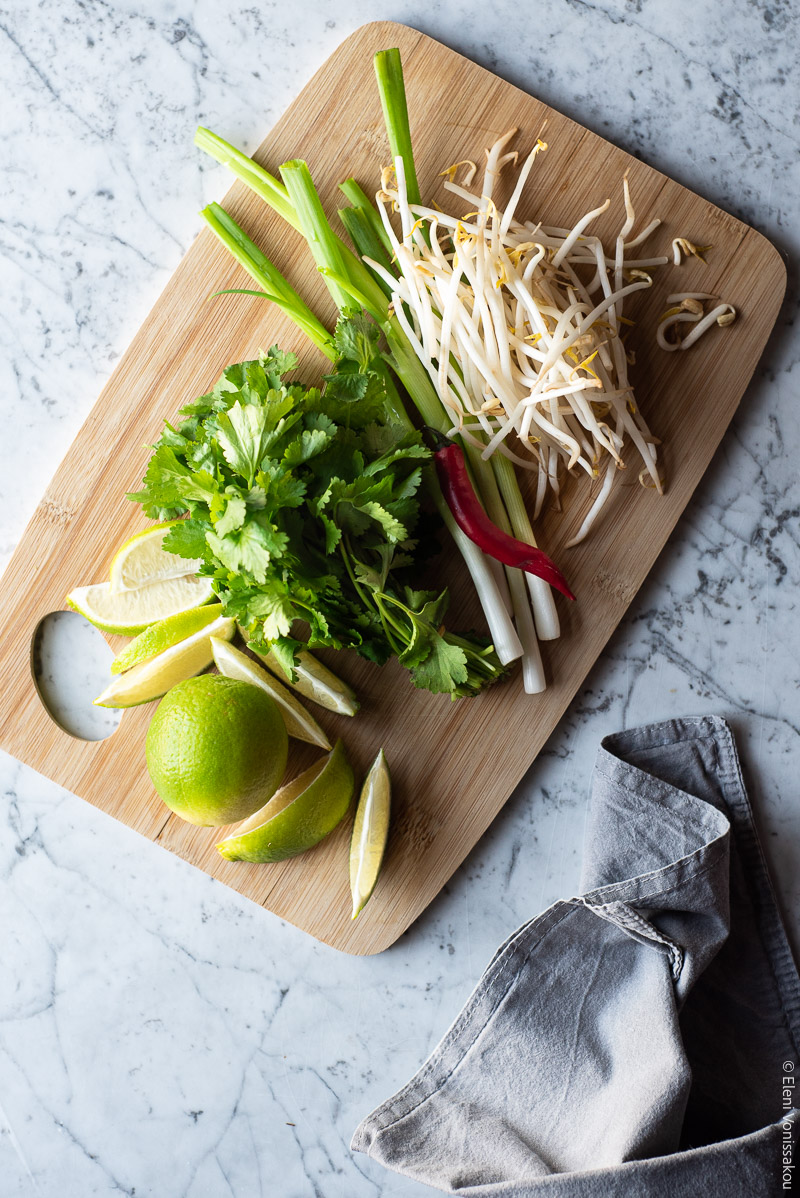 Mushroom Soup with Stelline Pasta, Inspired by Vietnamese Pho www.thefooodiecorner.gr Photo description: A chopping board with garnishes of coriander leaves, bean sprouts, spring onions, chilli pepper and lime wedges.